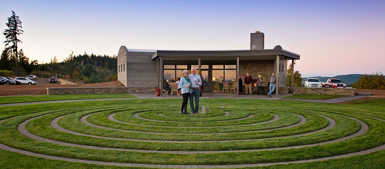 Fairsing Vineyard owners in the center of meditative labyrinth just outside of the tasting room in Oregon's Willamette Valley