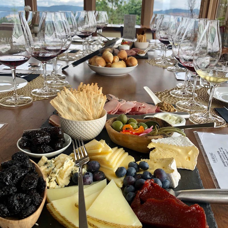 An elevated seated tasting at Fairsing Vineyard showcases estate wine including Pinot noir and Chardonnay with a generous array of culinary offerings with sumptuous views of Oregon's Willamette Valley