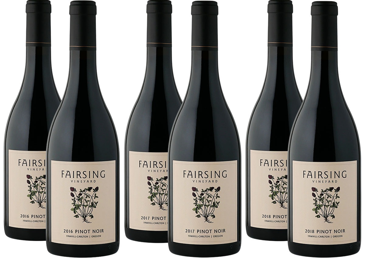 Six bottles of Fairsing Vineyard Pnot noir from the 2016, 2017, and 2018 vintages with blooming crimson clover on the label 