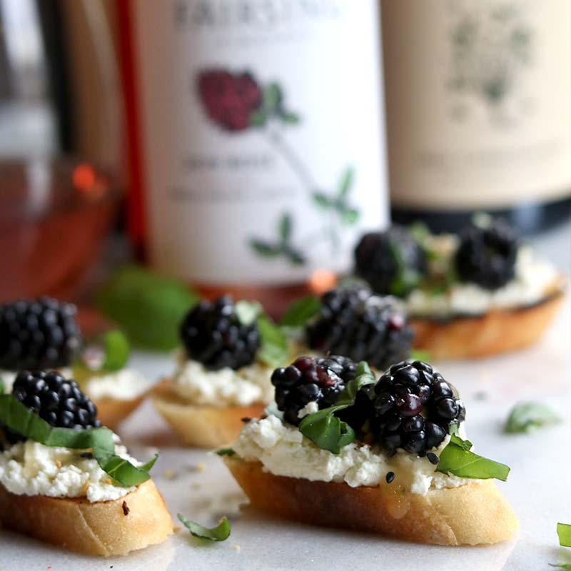 Discover culinary creations to pair with Fairsing Vineyard wines like this whipped goat cheese and blackberry crostini with fresh basil and honey