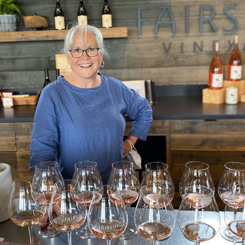 Fairsing Vineyard owner Mary Ann McNally smiles after pouring the estate Rosé of Pinot noir