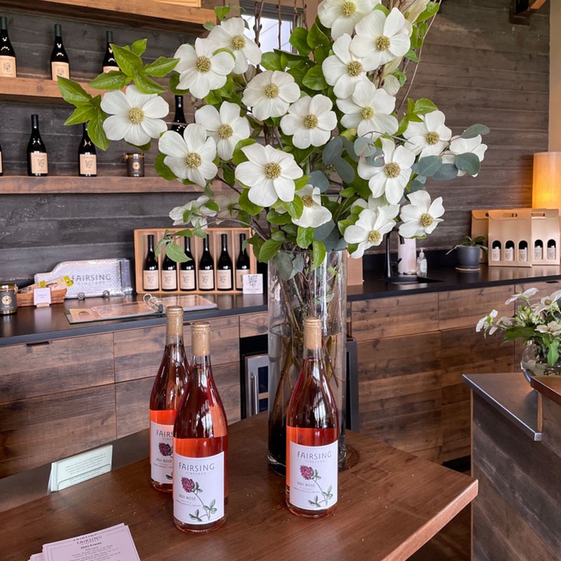 Dogwood blooms and bottles of Fairsing VIneyard Rosé of Pinot noir greet Wine Club members at their spring gathering