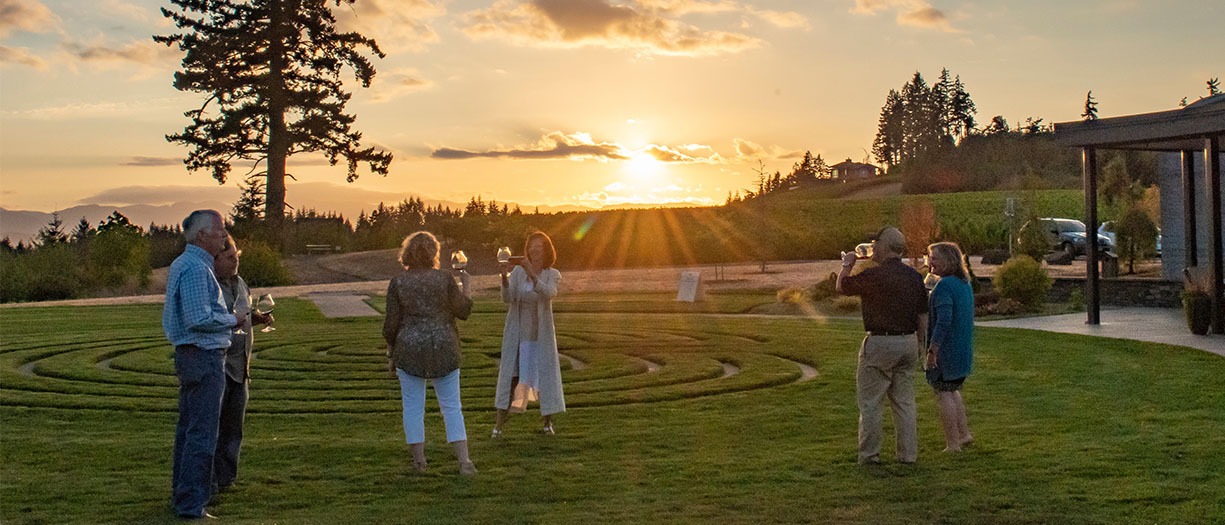 Fairsing Vineyard Wine Club members enjoy the sunset over the Oregon Coast Range with glasses of Pinot noir