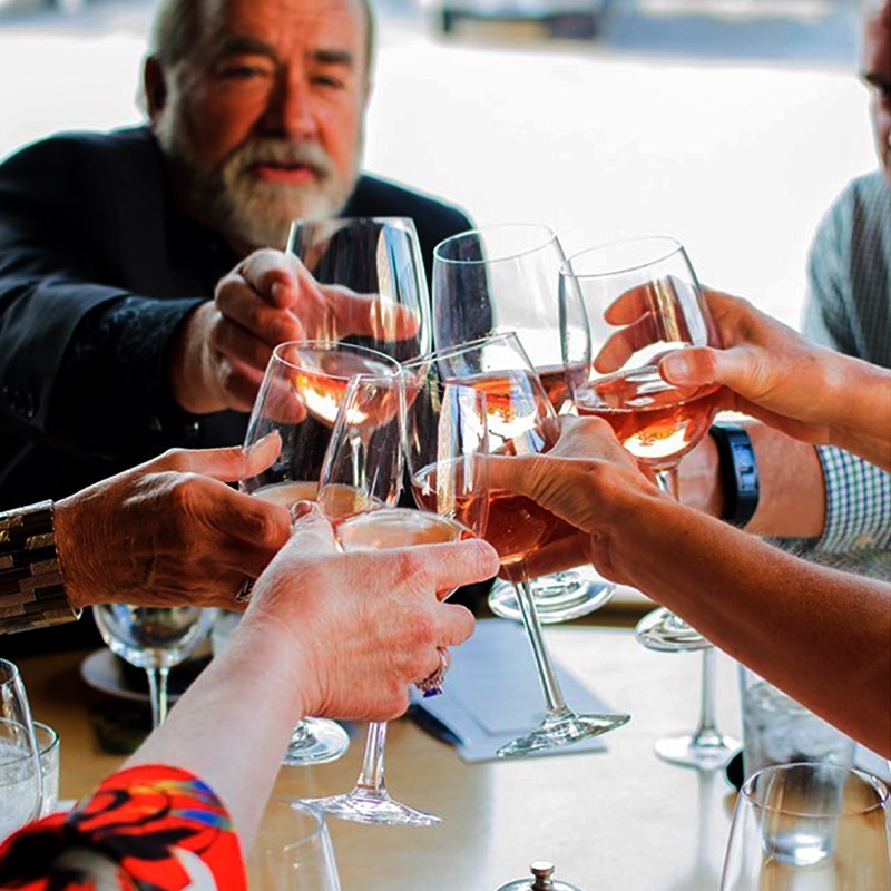 Fairsing Vineyard Wine Club members clink glasses and enjoy the estate Pinot noir from the sustainable estate